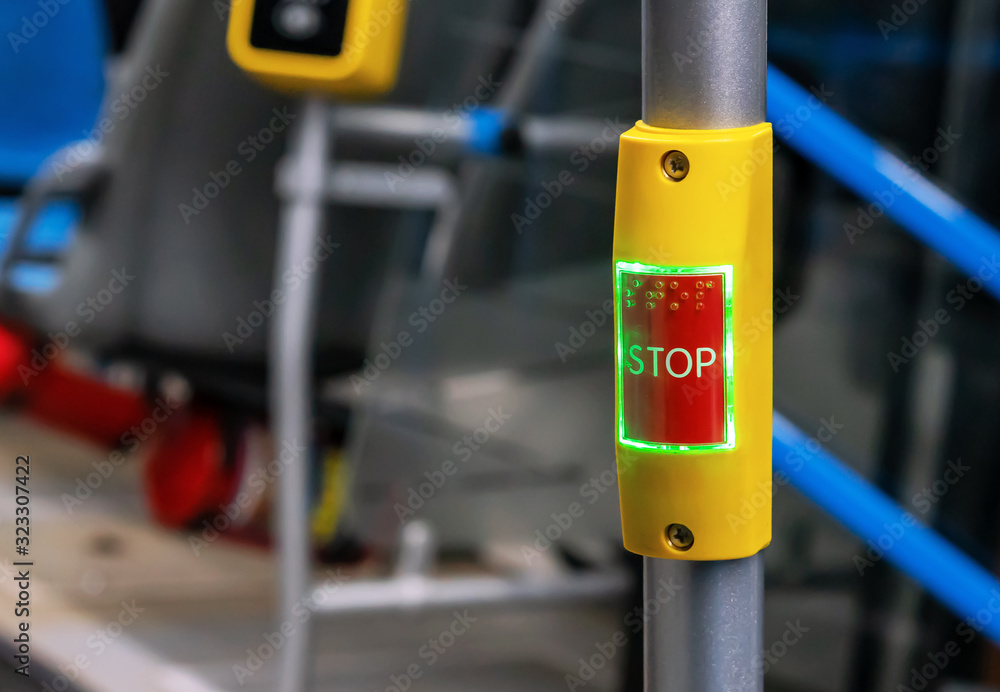 Red stop button in public transport. Bus stop button at the request of the passenger. - obrazy, fototapety, plakaty 