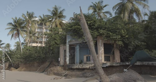 Pan across abandoned beach house devastated by hurricane damage photo