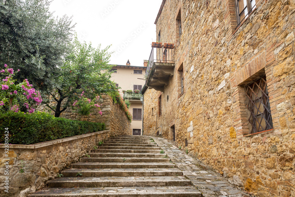 a street with stairs in San Quirico d'Orcia, Province of Siena, Tuscany, Italy