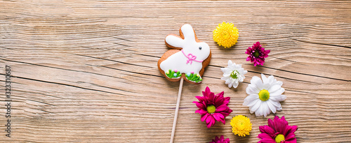 Easter cookies on wooden background, gingerbread in the shape of a rabbit