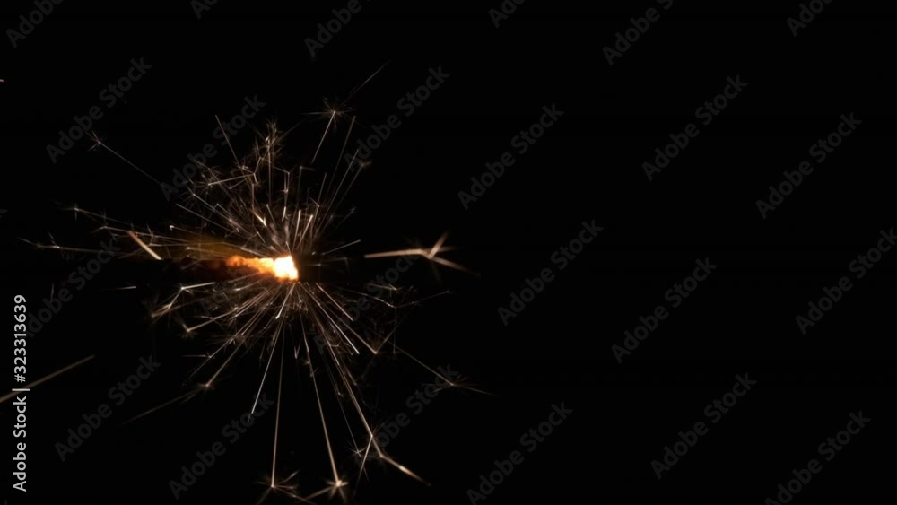 Slow motion, close-up of sparklers burning and sparking in the dark. Slow motion, close-up of sparklers burning and sparking in the dark.