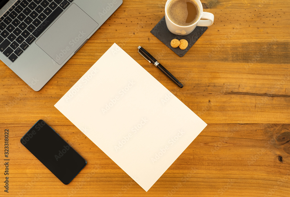 Table Top desk view with pencil a plant, coffee, workspace, mobile display and laptop, white paper Table Top desk view with pencil a plant, coffee, workspace, mobile display and laptop, white paper