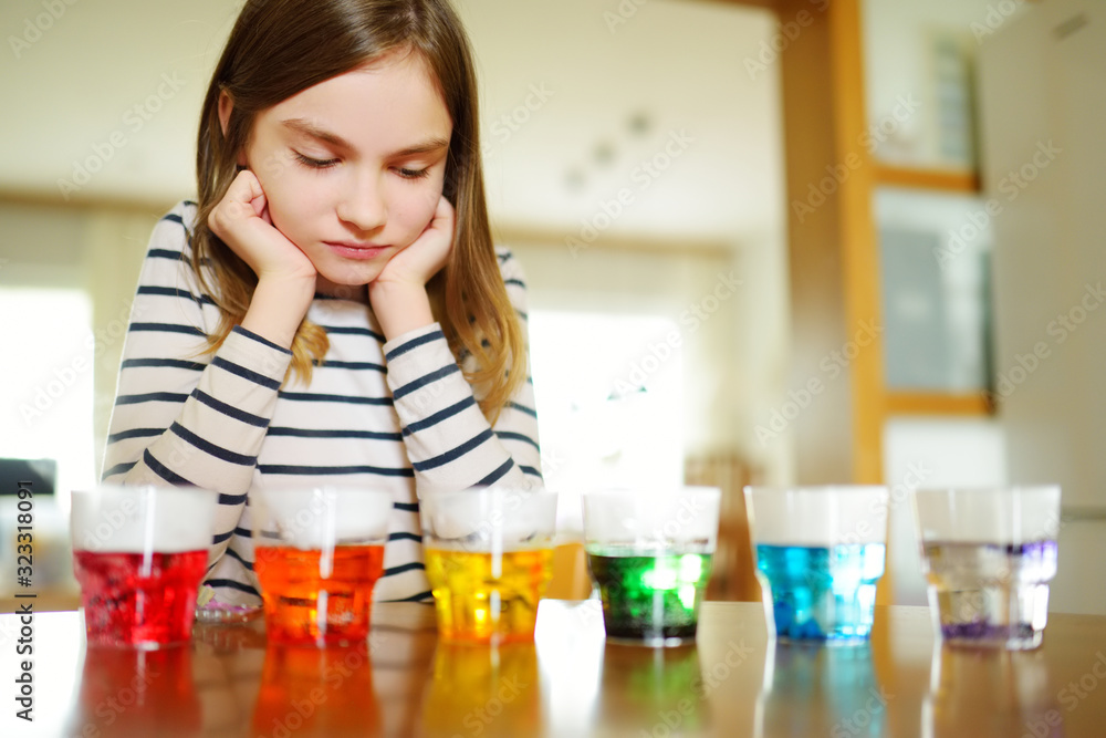 Cute young girl dyeing Easter eggs at home. Child painting colorful eggs for Easter hunt. Kid getting ready for Easter celebration. Cute young girl dyeing Easter eggs at home. Child painting colorful eggs for Easter hunt. Kid getting ready for Easter celebration.
