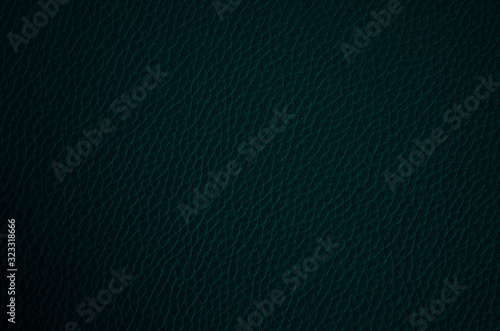 Leather texture close up. Dark blue fashionable background, top view. Stylish wallpaper of snake skin. Rough surface of navy blue color.