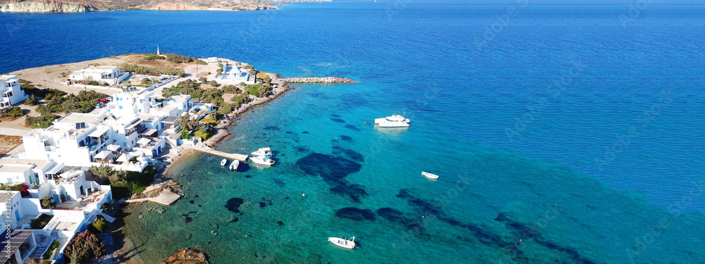 Naklejka premium Aerial drone ultra wide photo of traditional Cycladic seaside village of Apolonia in volcanic island of Milos, Cyclades, Greece