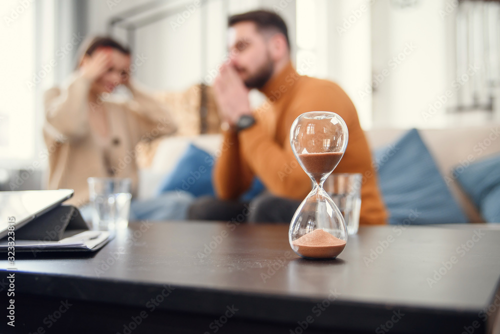 Couple sitting with psychologist during the mental therapy, cropped image with no face Couple sitting with psychologist during the mental therapy, cropped image with no face