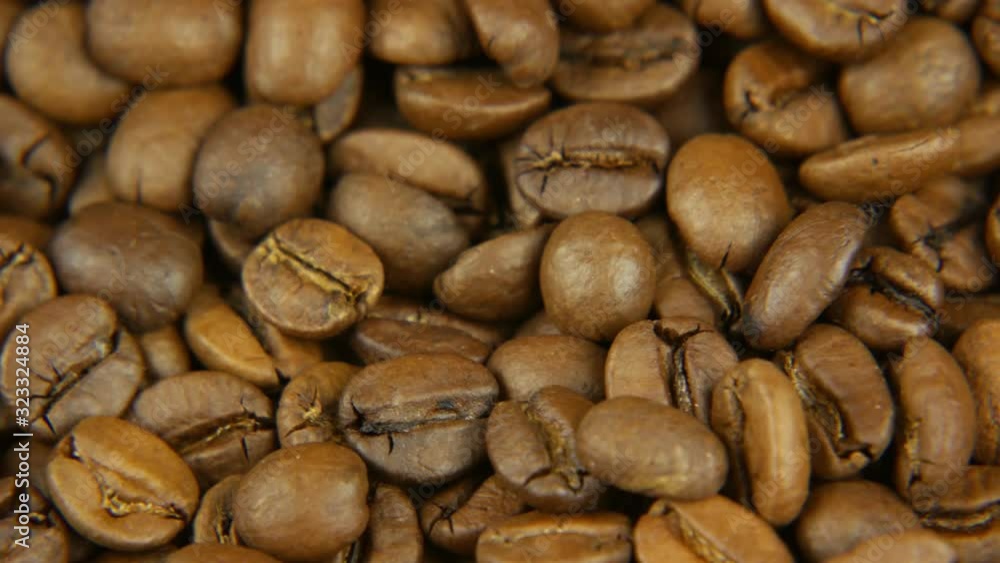 Roasted coffee beans caramel color rotating counterclock-wise Roasted coffee beans caramel color rotating counterclock-wise