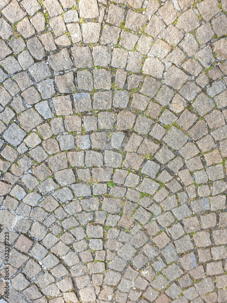 Top view of footpath tiles. Cobble Eath tone stone arrange as wave.
