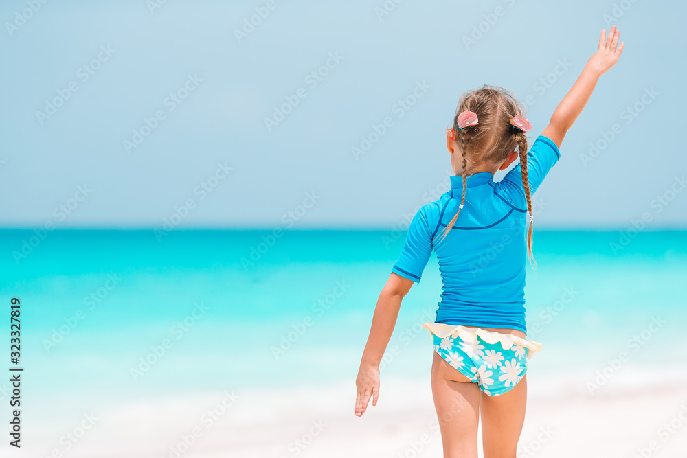 Cute little girl at beach during caribbean vacation Cute little girl at beach during caribbean vacation