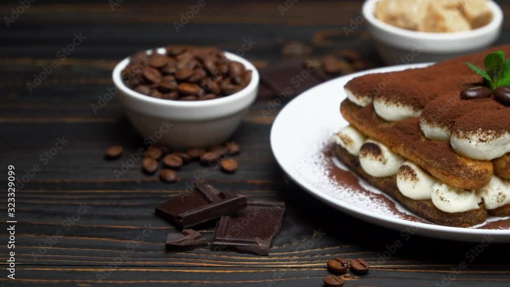 portion of Classic tiramisu dessert, cup of coffee and milk or cream on wooden background portion of Classic tiramisu dessert, cup of coffee and milk or cream on wooden background