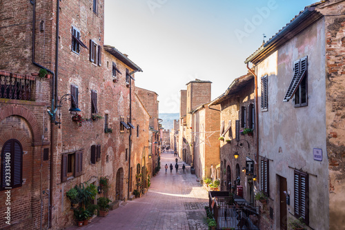 Fototapeta Naklejka Na Ścianę i Meble -  Certaldo, Tuscany, Italy - December 2019: View of the main cobbled street in the medieval town of Certaldo, Tuscany, Italy