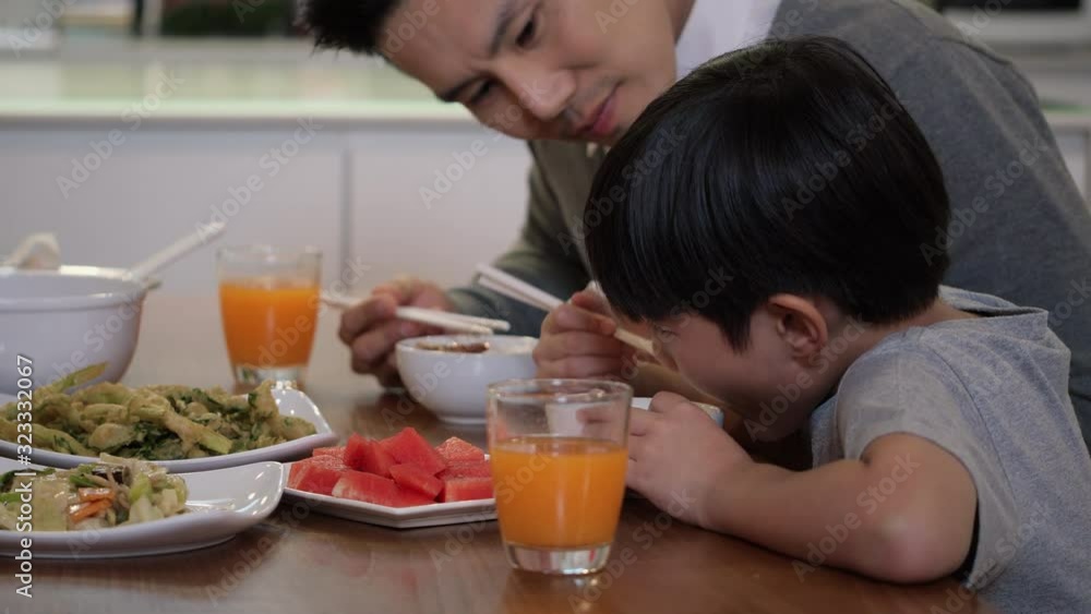 Happy anniversary asian family sitting light meal in the kitchen room at home together. Father and mother eating food with son and daughter. concept of family and edicatuon. Happy anniversary asian family sitting light meal in the kitchen room at home together. Father and mother eating food with son and daughter. concept of family and edicatuon.