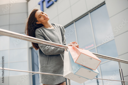 Beautiful girl in a summer city. Lady with shopping bags