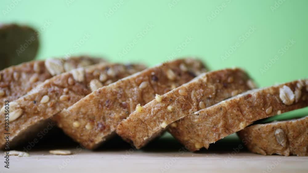 Whole grain bread on wooden table against green screen Whole grain bread on wooden table against green screen