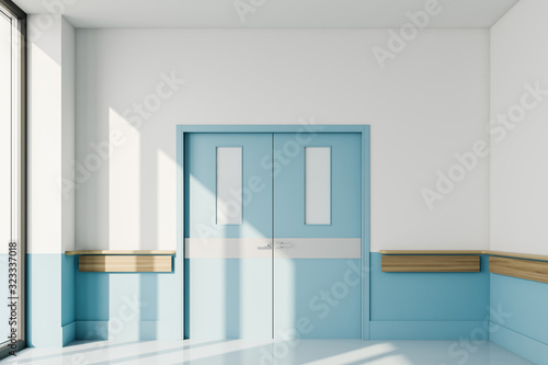 Blue closed door in empty hospital hall