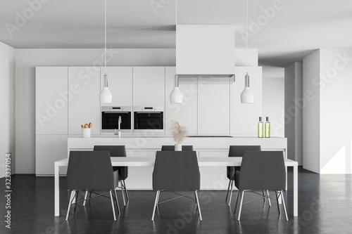 White kitchen with table and island, front view