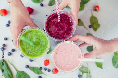 Row of healthy fresh fruit and vegetable smoothies with assorted ingredients