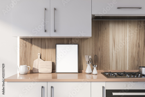 Poster on white countertop in wooden kitchen