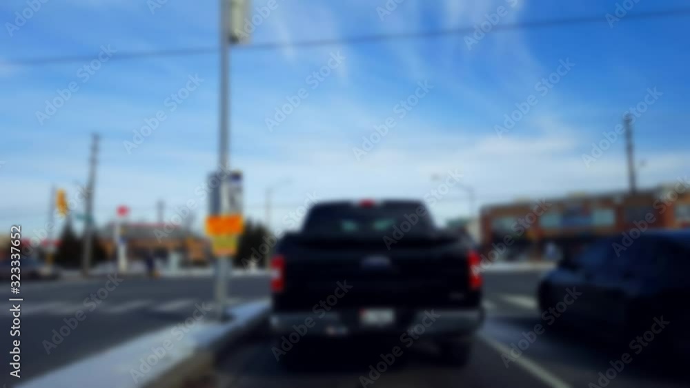 Waiting to Turn Left at City Light Intersection With Blur Effect. Being Patient to Turn in Urban Intersection With Traffic in Day. Waiting to Turn Left at City Light Intersection With Blur Effect. Being Patient to Turn in Urban Intersection With Traffic in Day.