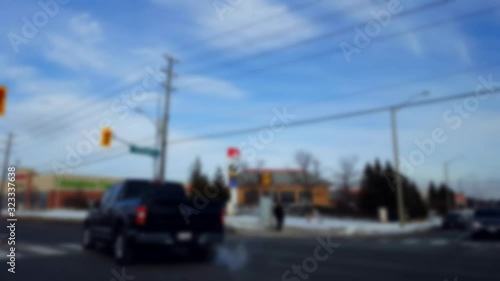 Turning Left at City Light Intersection With Blur Effect.  Turn in Urban Intersection With Traffic in Day.