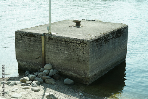 Bollard is iron post built in beton to fsten ship or boat. photo