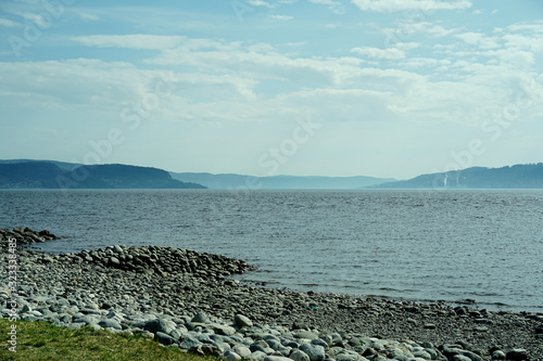 View of fjord in Drammen and stoun shore on foreground.