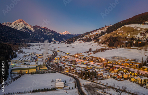 San Candido Innichen by sunrise in South Tyrol Alto Adige, Italy during winter season. Aerial drone shot in january 2020 photo