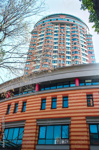 Multi-storey house with business center on sky background