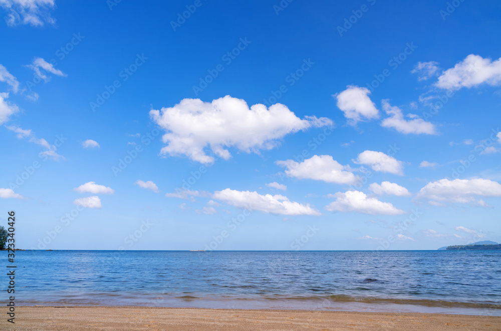 Empty tropical beach with clear blue sky and white clouds in summer season background.
