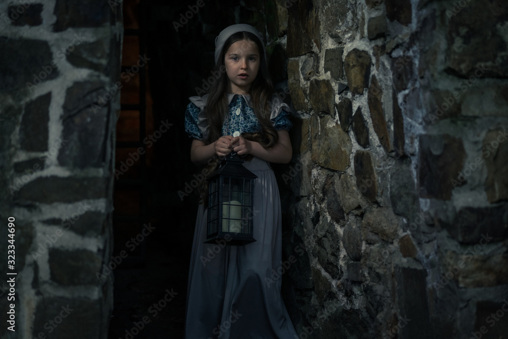 Frightened girl in the dungeons of an ancient castle. In her hand lantern. Frightened girl in the dungeons of an ancient castle. In her hand lantern.