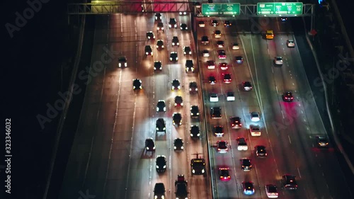 Aerial, tilt, drone shot, over rush hour traffic on The Pasadena Freeway 110, in downtown Los Angeles, night time, California, USA photo