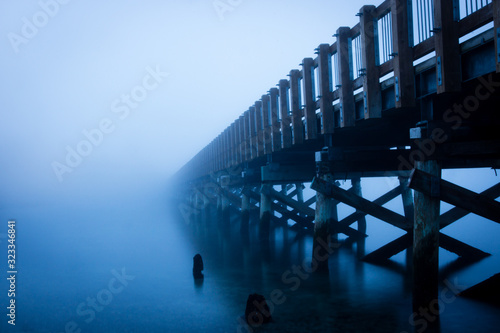 Taylor Dock foot bridge in Bellingham, Washington, disappears into the winter fog along the Salish Sea.