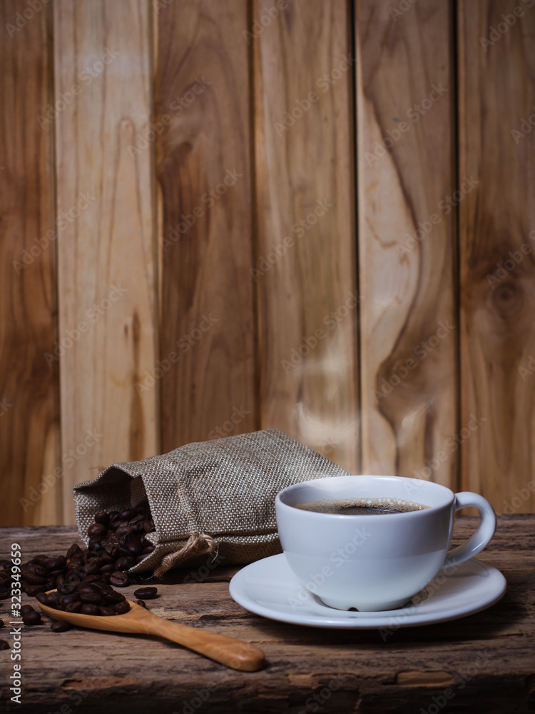 Coffee in a white cup and seeds Coffee on a wooden table - obrazy, fototapety, plakaty 