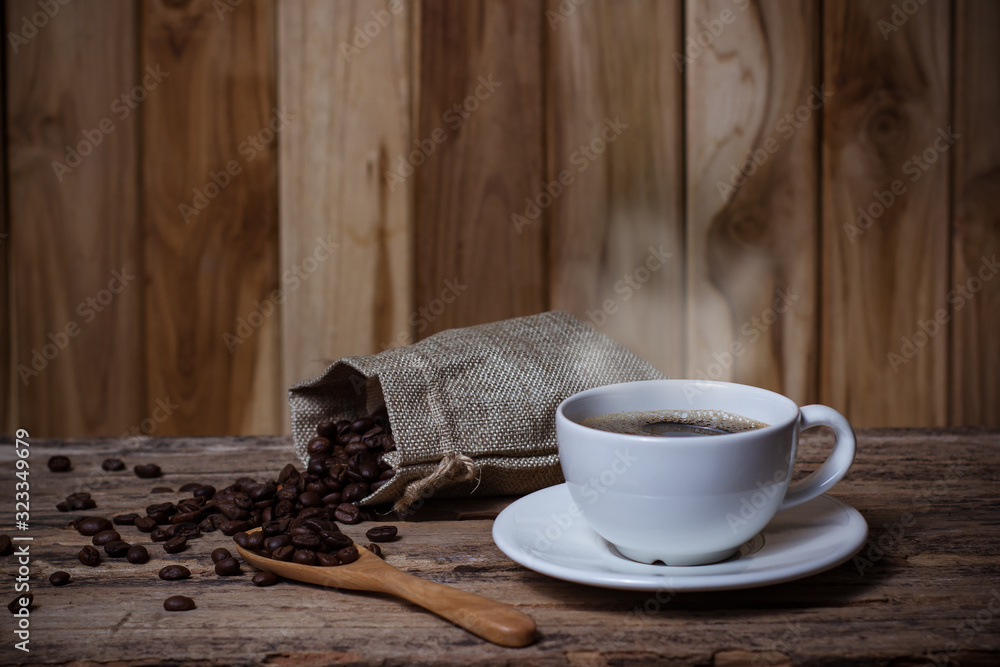 Coffee in a white cup and seeds Coffee on a wooden table - obrazy, fototapety, plakaty 