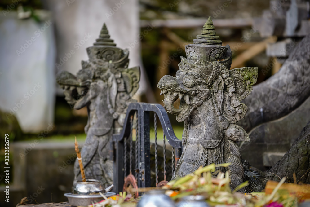 Balinese sculptures and traditional architectural details in a temple near Ubud, Bali, Indonesia