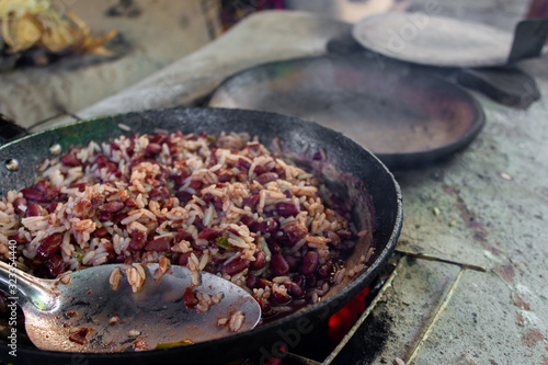 cooking traditional Nicaraguan food known as gallo pinto and tortillas on a wood fire photo