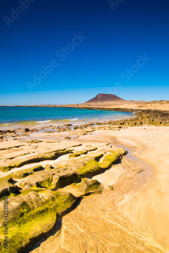 Obraz na płótnie Beautiful landscape view on La Graciosa Island coastline, on the walking path from Caleta del Sebo to Montana Amarilla volcano. Popular tour from Orzola - Lanzarote, Spain w salonie