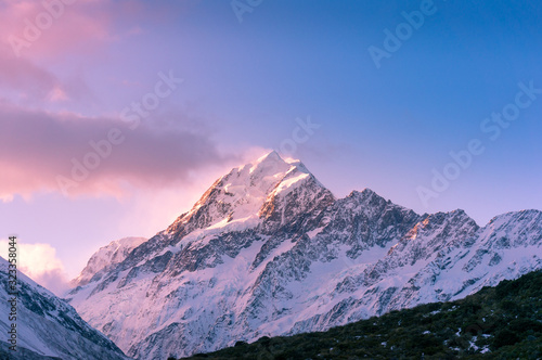 Snow covered mountain peak at sunset. Winter mountains landscape © Olga K