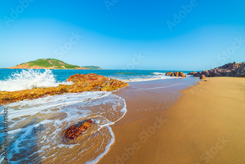 Fototapeta Naklejka Na Ścianę i Meble -  Gorgeous tropical beach turquoise transparent water unique rock boulders, Quy Nhon Bai Xep Vietnam central coast travel destination, desert golden sand beach no people clear blue sky