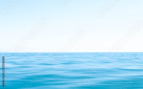 Smooth surface of the ocean and blue sky Use techniques panning and low shutter speeds