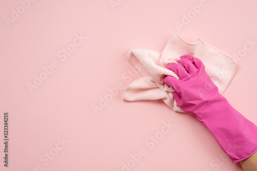 Hand in latex gloves and cloth on a horizontal surface