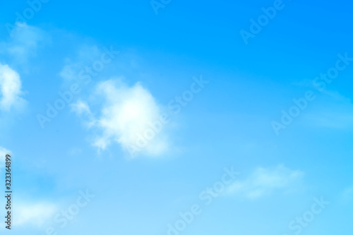    blue sky against white floating clouds background