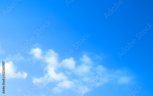 ิblue sky against white floating clouds background