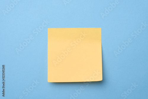 Yellow sticky note on light blue background