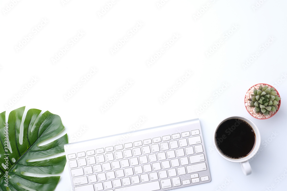 Flat lay top view office desk. Workspace, computer keyboard,cactus, green leaf, and coffee cup on white background. Flat lay top view office desk. Workspace, computer keyboard,cactus, green leaf, and coffee cup on white background.