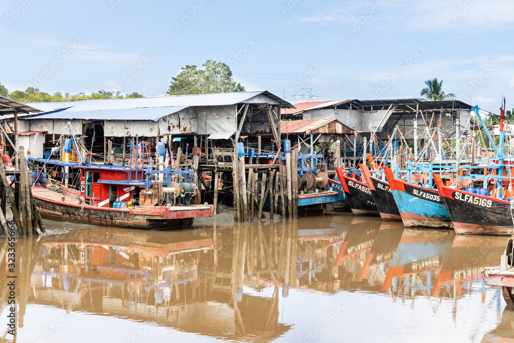 SEKINCHAN, MALAYSIA, February 16, 2020: Sekinchan is source of fresh seafood. Feature here is old fashion fisherman boat docked at jetty. SEKINCHAN, MALAYSIA, February 16, 2020: Sekinchan is source of fresh seafood. Feature here is old fashion fisherman boat docked at jetty.