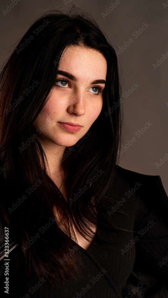 High Fashion girl model look in black suit. Studio shot of slim sexy brunette wears bra and black jacket. Stylish portrait of woman with bob hairstyle and makeup isolated on grey background. High Fashion girl model look in black suit. Studio shot of slim sexy brunette wears bra and black jacket. Stylish portrait of woman with bob hairstyle and makeup isolated on grey background.