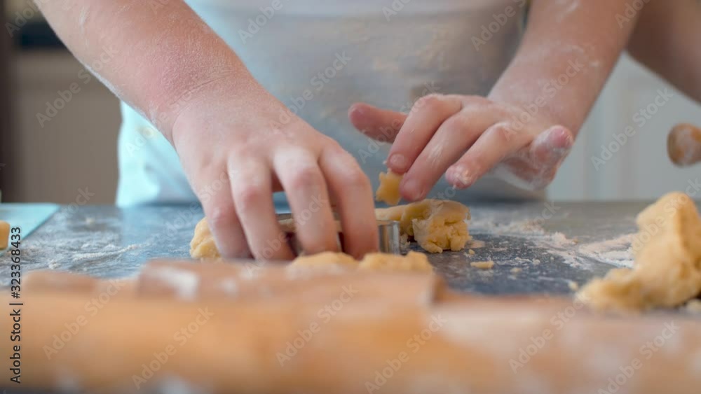Girl taking cookies out of cookie cutter Girl taking cookies out of cookie cutter