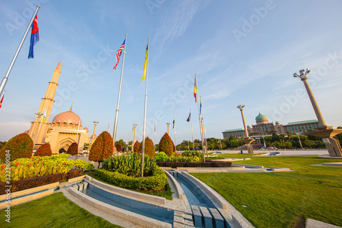 Putra Mosque Or Masjid Putra Principal Mosque Of Putrajaya Wilaya Malaysia In The Early Morning For Sunrise In Foreground The Malaysian Flag With The State Flags Of All Malaysian States Stock Photo