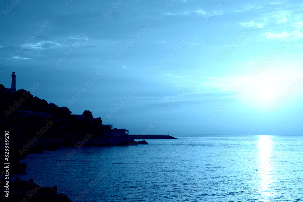 Sunrise over the sea near the coast of Sicily, Italy. Natural bakground blue color toned